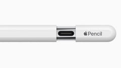 A close-up of a white Apple Pencil showing the center section with a USB-C connector and the Apple Pencil logo on the cap, set against a plain white background.